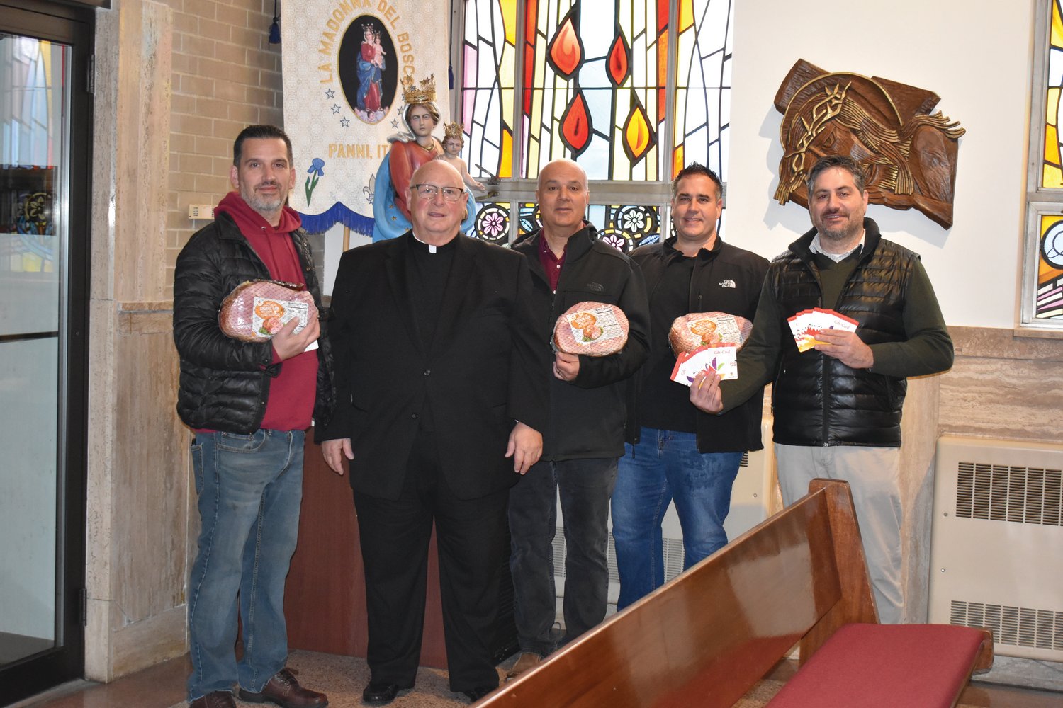 PROUD PANNESE PE0PLE: Rev. Peter J. Gower (second left), popular pastor at Our lady of Grace Church, is joined by President David Venditelli (left), Secretary Louis Mansolillo, Vice President Jason Parenteau and Treasurer Stephen Russo during the recent spiral ham donation  in Johnston.